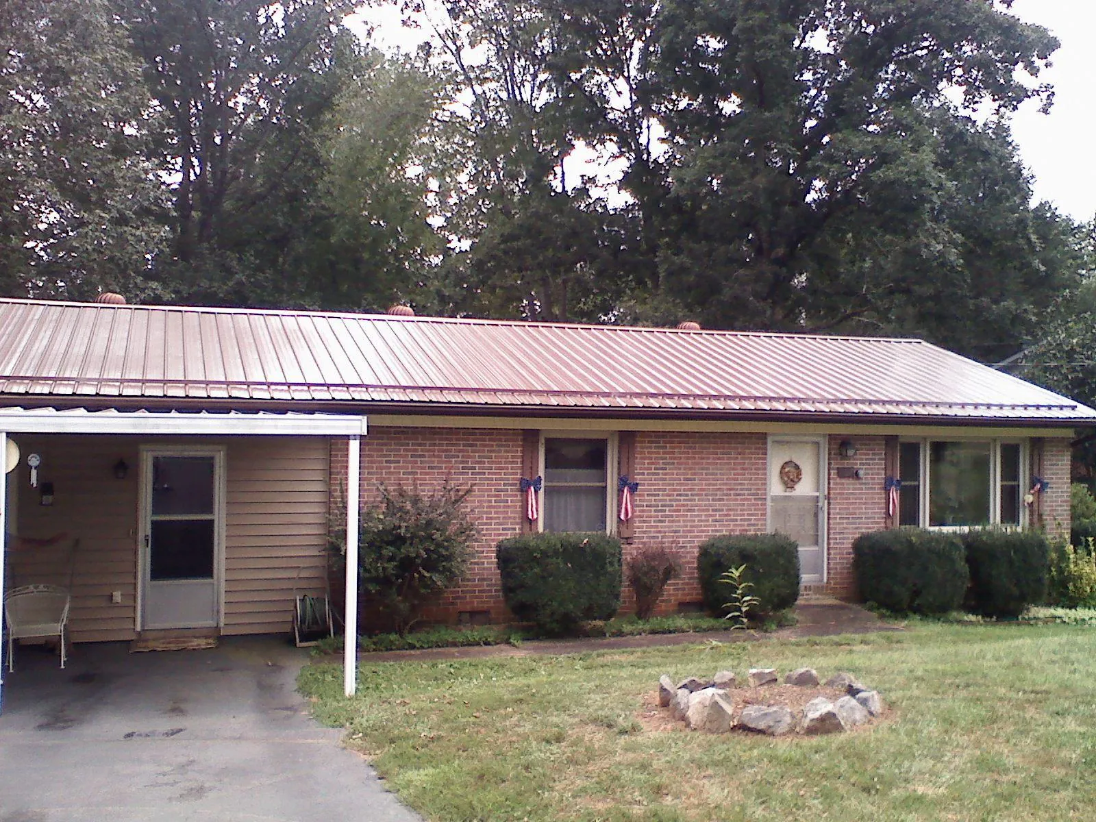 Bronze metal roof and carport on a brick ranch home — Roof Repair work by our crew in Silverton
